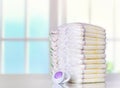 Stack of diapers on table indoors. Royalty Free Stock Photo