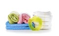 Stack of diapers with towels and baby teether on white background Royalty Free Stock Photo
