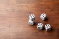 Stack of dice on rustic wooden table. Gambling devices. Game of chance concept. Copy space for text. Royalty Free Stock Photo