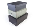 Stack of different black and gray closed cardboard shoe boxes