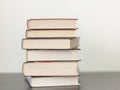 A stack of different books in a thick cover on the table