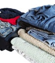 Stack of different clean clothes isolated on white background, close-up. Royalty Free Stock Photo