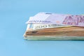 Stack with different euro banknotes isolated on a blue background. Much money. Royalty Free Stock Photo