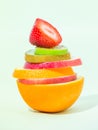 Stack of different fruit slices on sofe green background, concept for health care, fruit punch Royalty Free Stock Photo