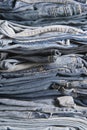 Stack of different old worn blue jeans Royalty Free Stock Photo