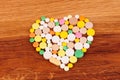 Heap of pills on wooden desk