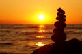 Stack of different stones in balance at the beach sunset Royalty Free Stock Photo