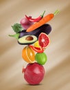 Stack of different vegetables and fruits on pale light brown background Royalty Free Stock Photo