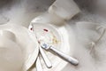 Stack Of Dirty Dishes And Silverware In Sink With Bubbles Royalty Free Stock Photo