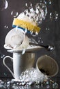 Stack of dirty white dishes on dark background with washing sponge and bubbles Royalty Free Stock Photo