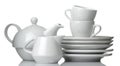 A stack of dishes. Dinnerware. plates, kettle and cup on a white isolated background. close-up Royalty Free Stock Photo