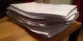 Stack of disorganized papers creating overwhelming paperwork pile Royalty Free Stock Photo
