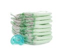 Stack of disposable diapers and pacifier on white. Baby accessories Royalty Free Stock Photo