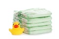 Stack of disposable diapers and toy duck on white. Baby accessories Royalty Free Stock Photo