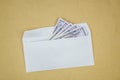 Stack of dollars in open envelope on brown background. Concept of corruption, illegal profit, racketeering Royalty Free Stock Photo