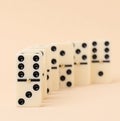 A stack of dominoes on a beige background, an intellectual game