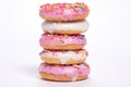 a stack of donuts with frosting and sprinkles