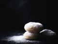 a stack of donuts with powdered sugar