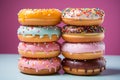 a stack of donuts with sprinkles and frosting