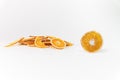 Stack of dried orange slices, and one slice in front, bright light. Dried fruit for dessert and tea Royalty Free Stock Photo