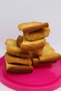 Stack of dry toast on Plastics plate. Close Up Pile of toasted bread slices. Toast loaf on white background Royalty Free Stock Photo