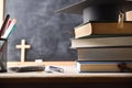 Stack of educational books and a mortarboard on desk Royalty Free Stock Photo