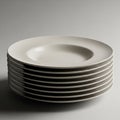 Eight white ceramic soup plates is neatly arranged against a gray Royalty Free Stock Photo