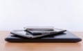 Stack of electronic gadgets on a table - notebook, tablet, ebook reader and a smatphone on the top Royalty Free Stock Photo