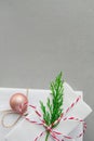 Stack of Elegant White Gift Boxes Tied with Red Ribbon Green Juniper Twig Ball. Christmas New Years Presents Shopping Sale. Royalty Free Stock Photo