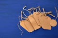 Stack of empty brown empty tags from kraft paper with ropes for clothes and other purposes