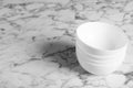 Stack of empty ceramic bowls on white marble table, space for text Royalty Free Stock Photo