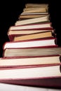 Stack of encyclopedia books over black background