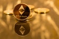 Stack of ethereum coins with gold background