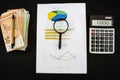 Stack with euro banknotes, calculator, pen and business graph on black. Economy concept, income analysis. View from above. Royalty Free Stock Photo