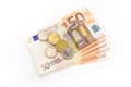 Stack of Euro banknotes and coins isolated. 50 Euro banknotes. Royalty Free Stock Photo