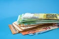 Stack with euro banknotes. Different euro banknotes isolated on a blue background. Financial concept. Much money. Royalty Free Stock Photo