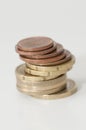 Stack of euro and euro cent coins on the gray background, the concept of savings Royalty Free Stock Photo