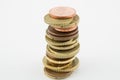 Stack of euro cents coins on white background. Currencies of different values, five, ten and twenty euro cents Royalty Free Stock Photo