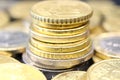 A stack of euro coins in denominations of 20, 50 euro cents and 1, 2 euros, surrounded by euro coins arranged around. Royalty Free Stock Photo