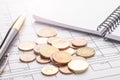 Stack of euro euro coins on old black wooden table. Pen, notebook and accounting documents with numbers Royalty Free Stock Photo