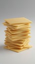 A stack of evenly cut, thin square slices of cheese, uniform in size, with a creamy Royalty Free Stock Photo