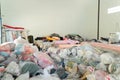 Stack of fabric raw material. Clothing in plastic bags in room. Stock in warehouse in storing industry concept