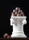 Stack of Fine Artisan Chocolates Stacked On White Pillar Column Royalty Free Stock Photo