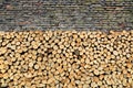 Stack of firewood against old weathered brick wall Royalty Free Stock Photo