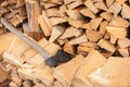 Stack of firewood with axe. Chopped logs with old axe. Woodpile background. Stacked wood. Logging storage. Harwood background. Royalty Free Stock Photo