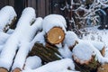 Stack of firewood covered with snow outdoors. Stack of wood cut. Snow on the timber stack. Wooden log store under snow white Royalty Free Stock Photo