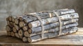 Stack of firewood logs tied with twine on a wooden table. Royalty Free Stock Photo