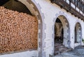A stack of firewood under the arch of a medieval house Royalty Free Stock Photo