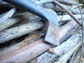 Stack of firewood wood sticks with axes on wood