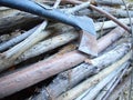 Stack of firewood wood sticks with axes on wood